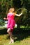 Young girl picking fruit from the plum tree