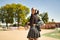 Young girl with pigtails, punk style, white headphones and inline skates hanging from the shoulder on their backs looking at