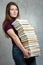 Young girl with a pile of books