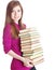 Young girl with pile of books in hands