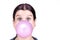 Young girl with a pink bubble of chewing gum