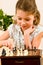 Young girl play chess cute smile