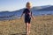 A young girl playing on the beach on a summers day