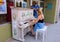 A young girl playing a piano outside an art gallery in southern ontario