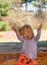 Young girl playing in a sandpit made from corn cob seeds