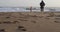 Young girl playing by the sea with her grandfather