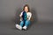 Young girl playing with shark toy in a yellow studio