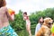 Young girl playing squirt guns with her brother on pier during summer