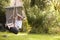 Young Girl Playing On Tire Swing In Garden