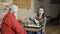 Young girl plays chess with grandfather