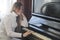 Young girl plays the piano - depressive concept