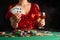 Young girl plays poker in a casino. Focus on playing cards in focus