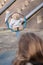 Young girl plays with teddy bear on a seesaw