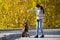 Young girl plays and trains her dog doberman. photo shoot on an autumn background