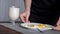 A young girl prepared scrambled eggs for breakfast and puts it on the table, and a glass of milk