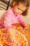 Young girl preparing homemade pizza