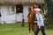 Young girl preparing horse for ride