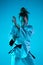 Young girl professional judoist isolated on blue studio background in neon light. Healthy lifestyle, sport concept.