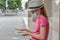 A young girl in a protective mask, counts dollar bills