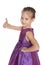 Young girl in the purple dress holds her thumb up