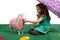 Young girl with purple parasol and toy lamb