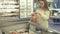Young girl it puts into plastic bag of frozen prawns in supermarket stock footage video