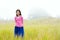Young girl quietly standing on misty foggy field