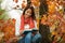 Young girl reading book in autumn park