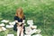 Young girl reading a book while lying in the grass. A girl among the books in the summer garden