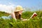 Young girl reading book in meadow