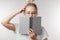 Young girl reading book over white background