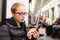 Young girl reading from mobile phone screen in metro.