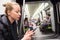 Young girl reading from mobile phone screen in metro.