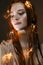 A young girl with red hair and with a luminous garland. Beautiful model with shining bulbs and lights. Gentle makeup.