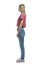 A young girl in a red tank top and jeans in profile. Full height. Isolated on a white background. Vertical