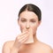 Young girl remove mascara from lips. skin care with cosmetic wipe
