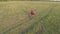 A young girl rides a bicycle on a rural road. Quadcopter shooting. View from above