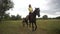 Young girl riding astride beautiful Brown horse