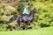 Young girl riding a black horse in autumn.