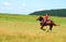 Young girl riding a horse at a rural event