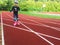 Young girl rollerskating in red running track