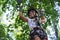 Young girl in a rope park in the summer to overcome the obstacle course