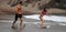 Young girl on a rope who is learning a skimboard