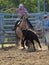 Young girl roping a young calf