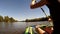 Young girl rowing in a kayak. Ukraine, Southern Bug river. Side view