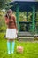 Young girl in rubber boots and basket with red