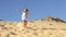 Young Girl Running Down Sand Dune