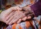 Young girl\'s hand touches and holds an old woman hand