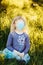 Young girl in sanitary face mask covering her face. Child wearing protective mask against coronavirus outdoors. Concept of panic,