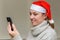 Young girl in santa claus hat talking on video communication with her friend